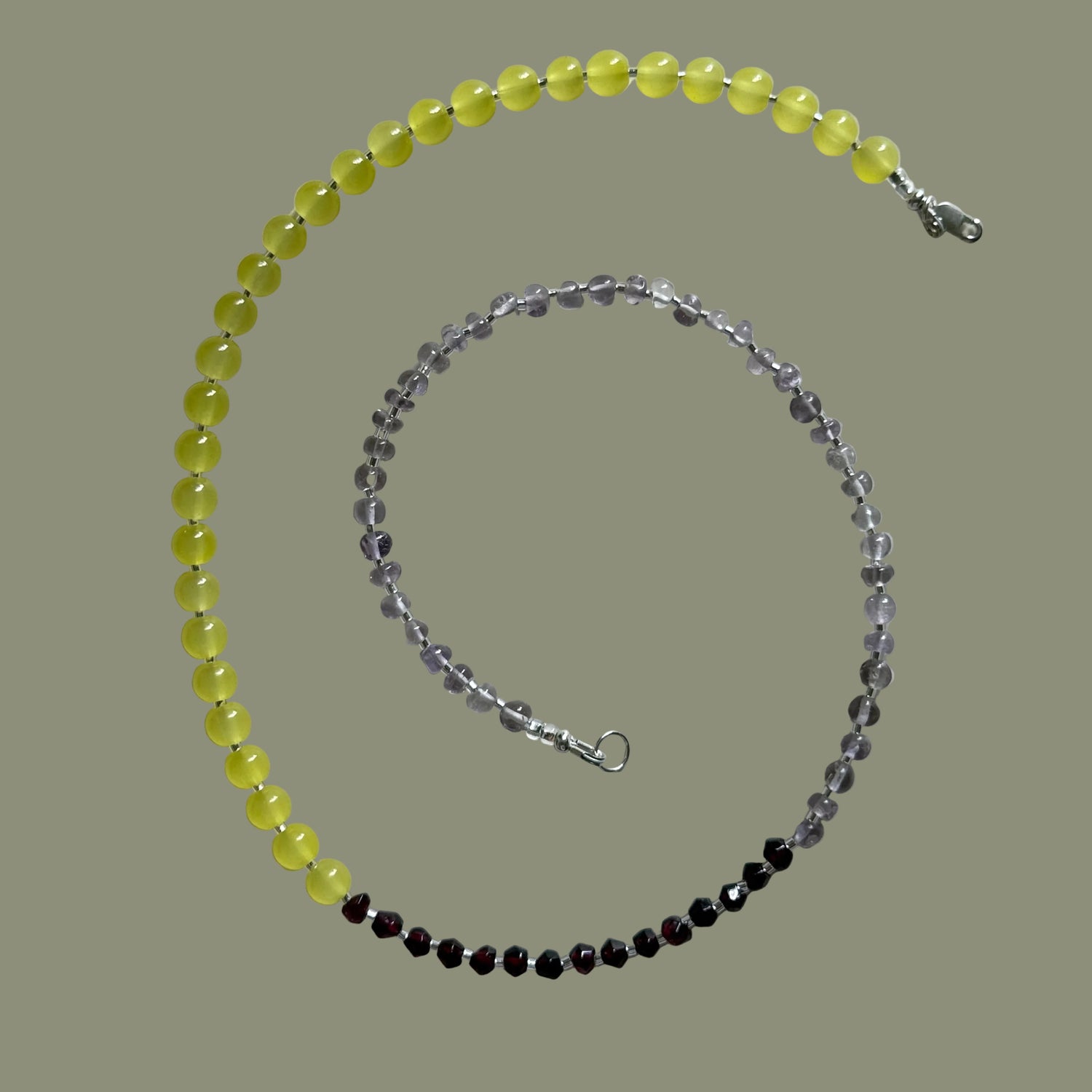 Two beaded necklaces on a light gray background