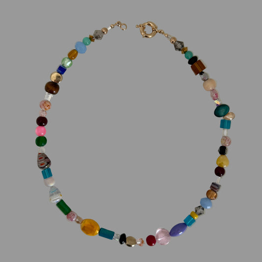 Multicolored beaded necklace on a light gray background