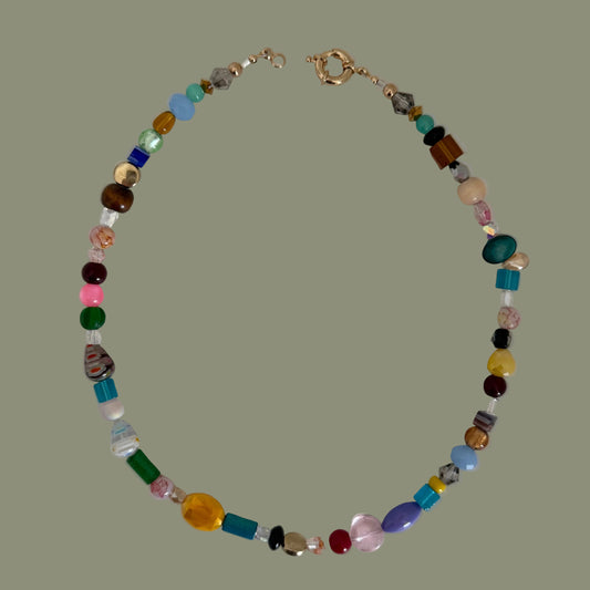 Multicolored beaded necklace on a light gray background