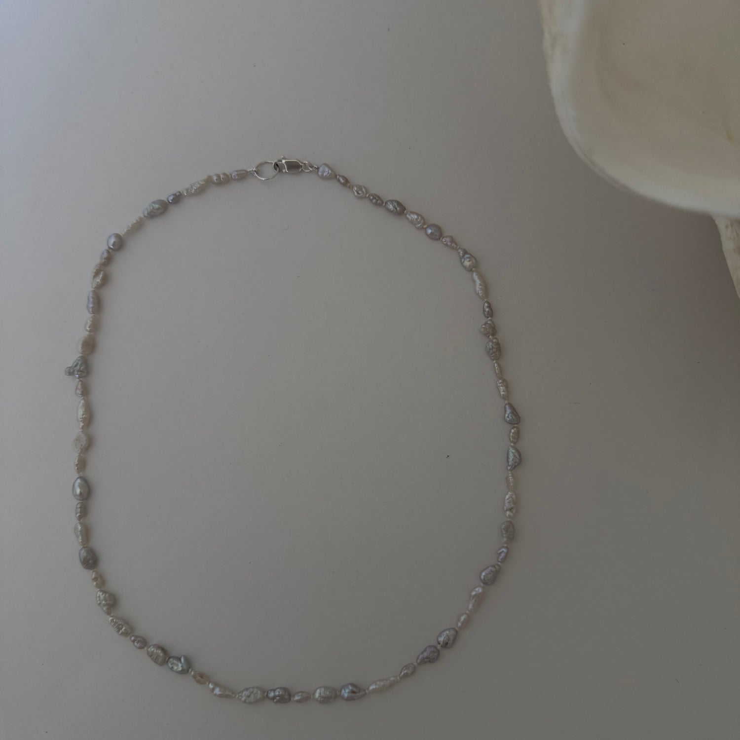 Pearl necklace on a light surface