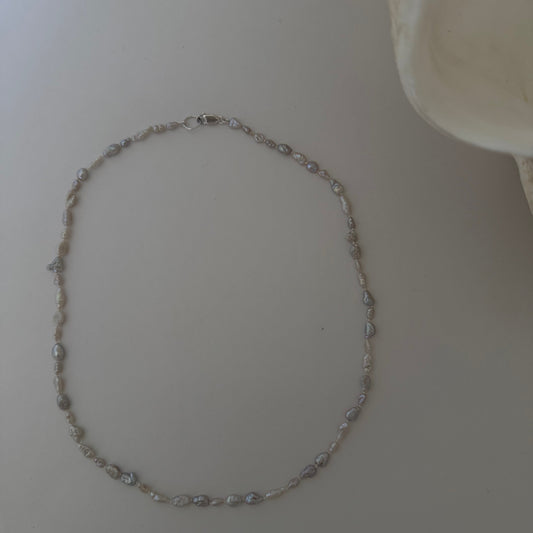 Pearl necklace on a light surface