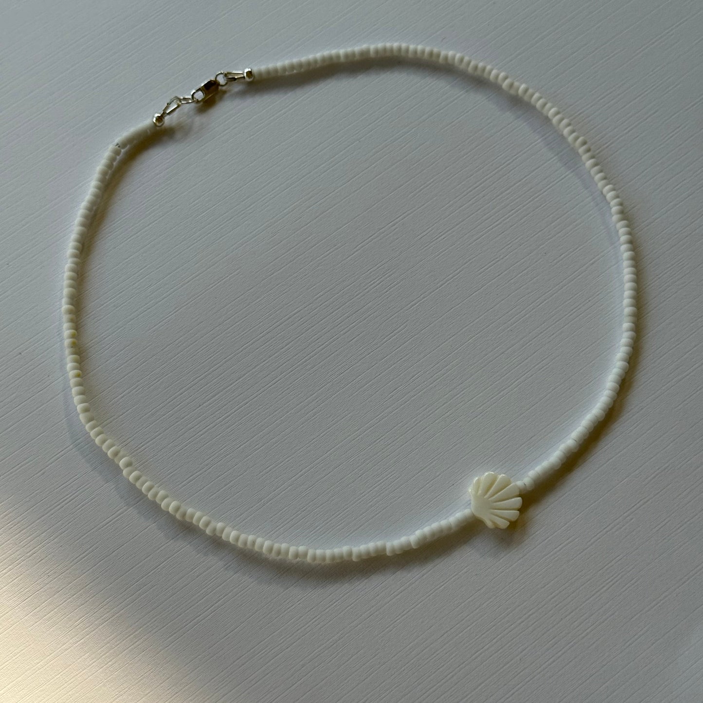 Necklace on a light gray background