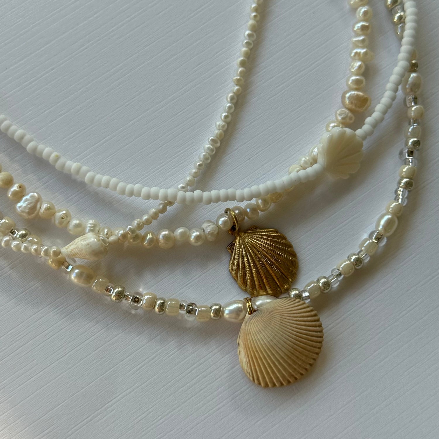 Necklace with gold shell pendants on a white background