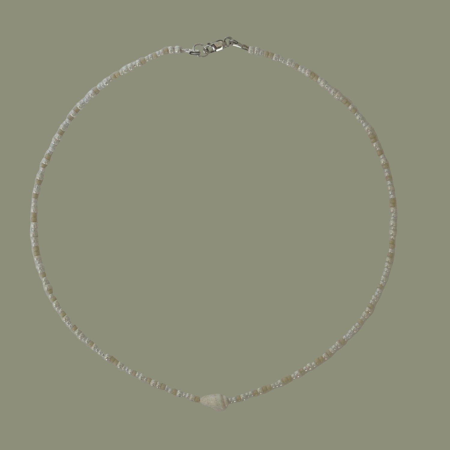 Necklace with small beads on a light gray background
