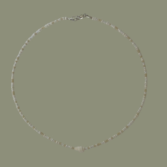 Necklace with small beads on a light gray background