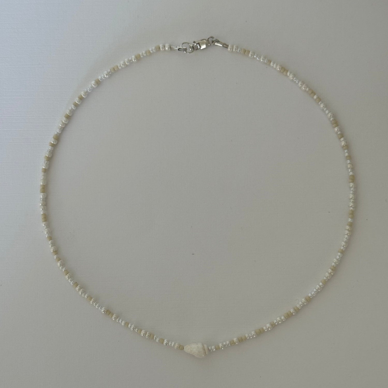 Pearl necklace on a plain white background