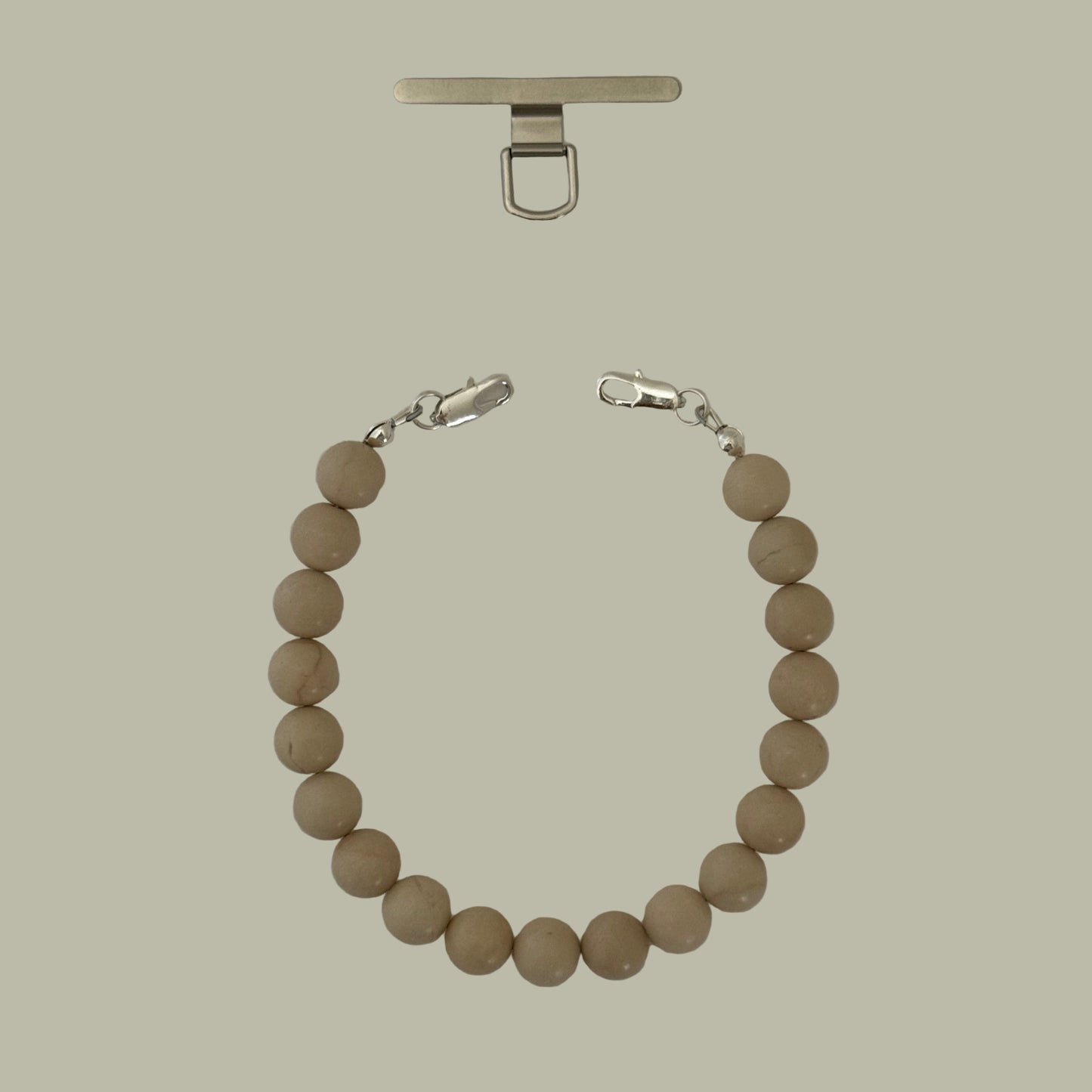 Beige beaded phone chain with silver clasp on a white background