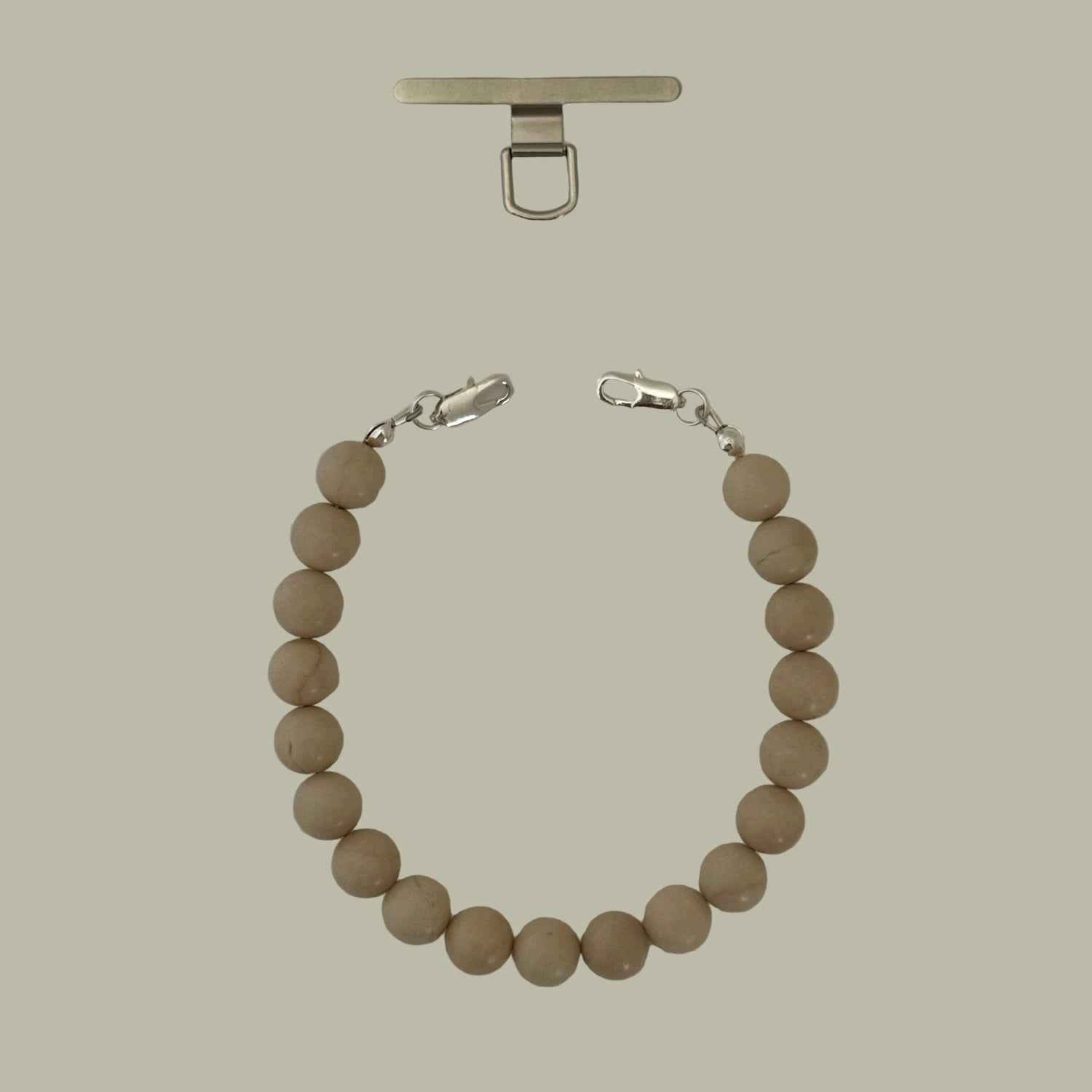 Beige beaded phone chain with silver clasp on a white background