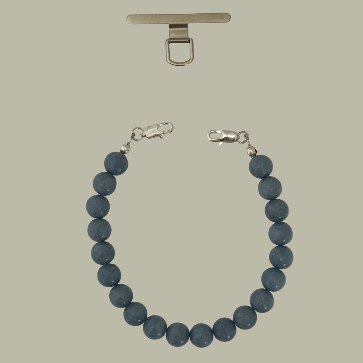 Blue beaded mobile phone chain with silver clasp on a light gray background