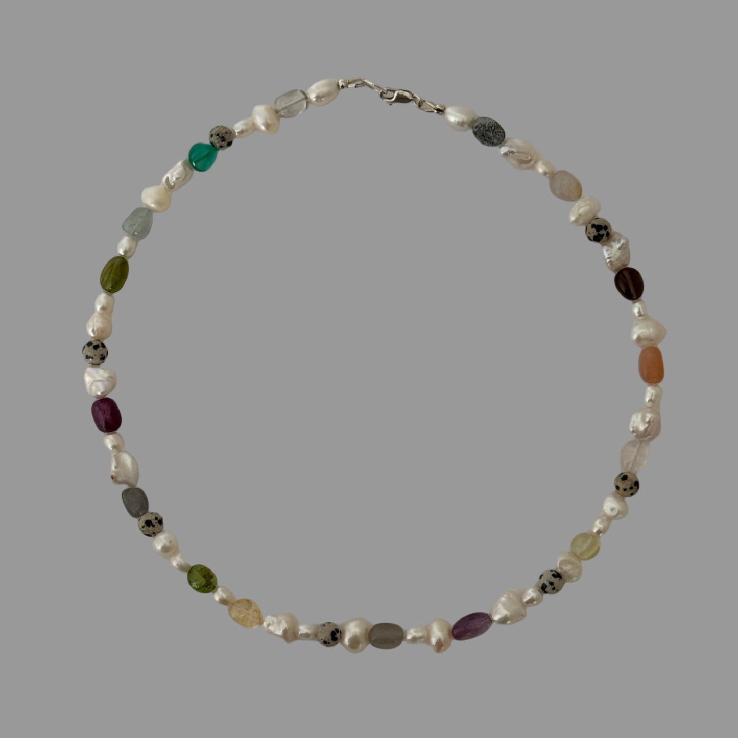 Necklace with multicolored beads on a light gray background