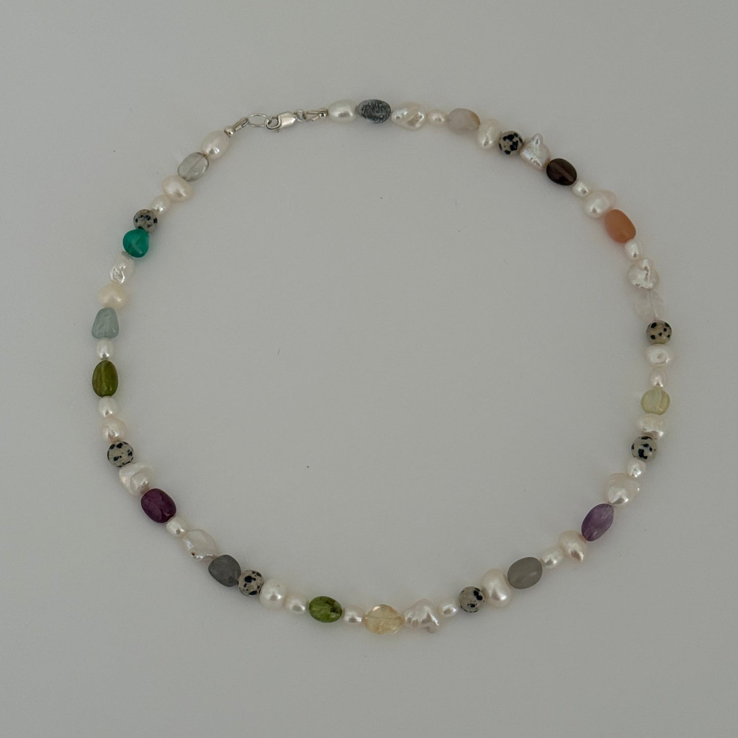 Necklace with multicolored beads on a gray background