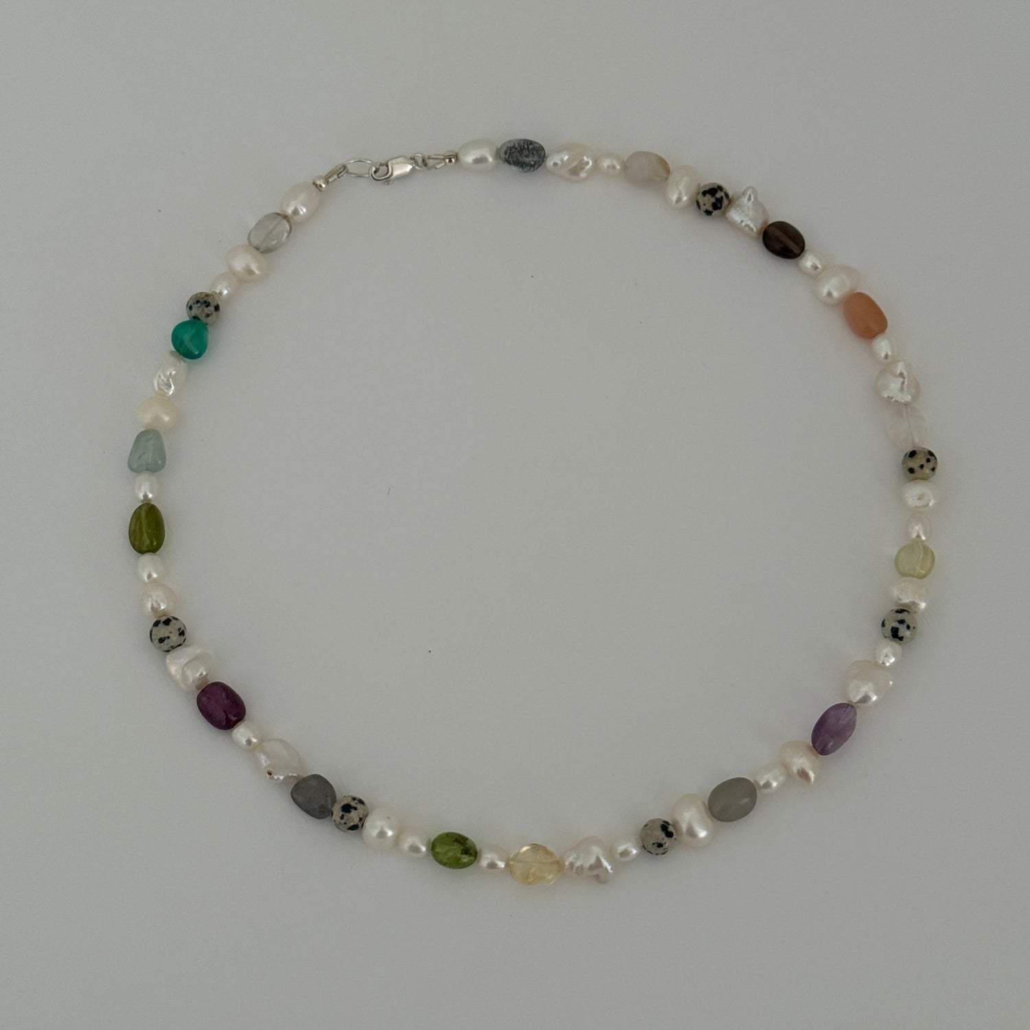 Necklace with multicolored beads on a gray background