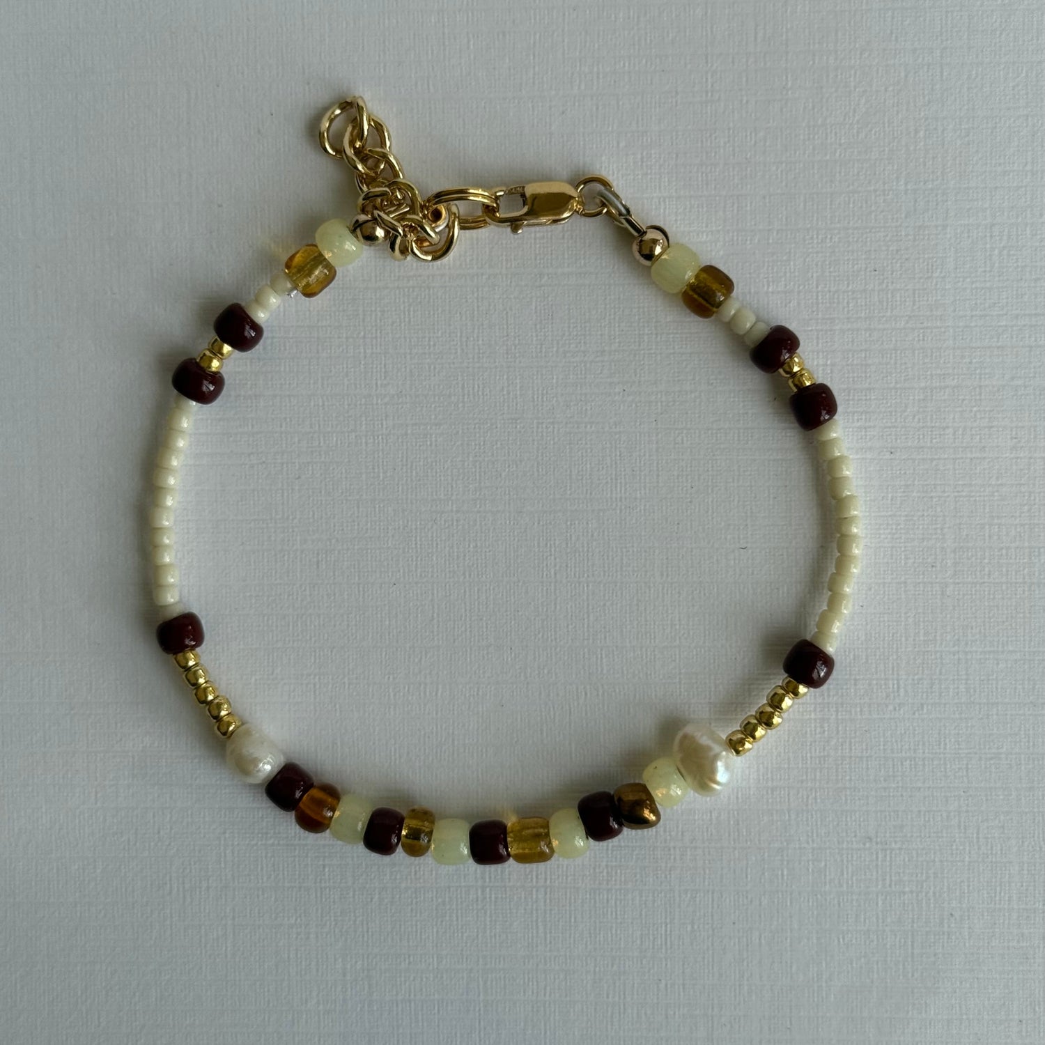 Bracelet with beads on a light gray background