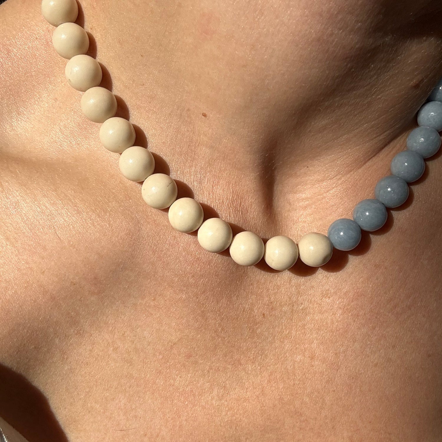 Close-up of a beaded necklace on a person's neck