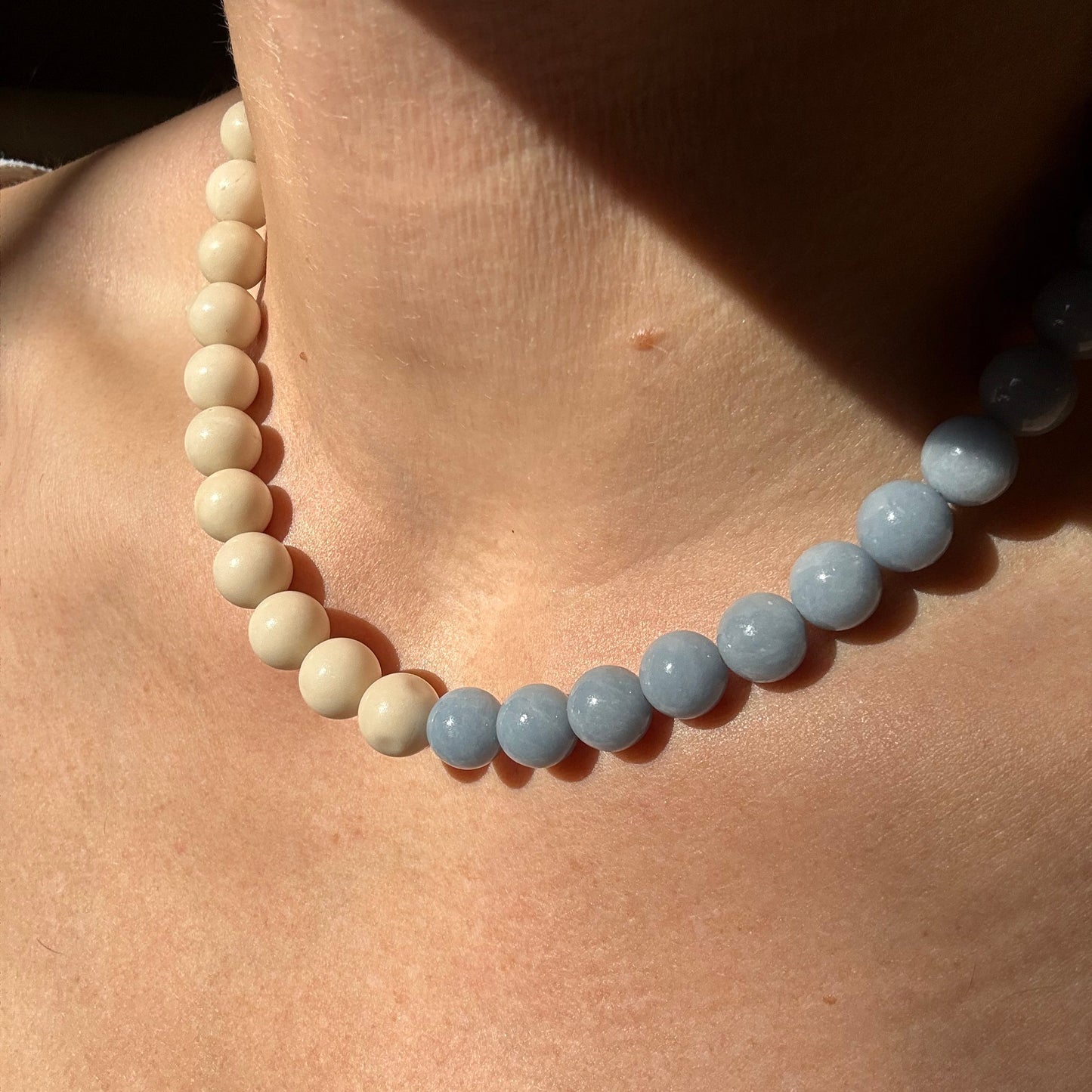 Necklace with blue and white beads on a wooden surface