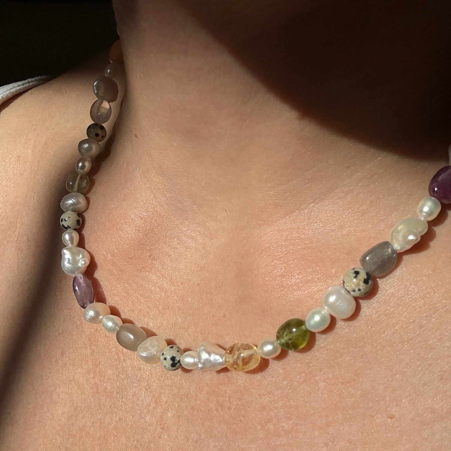 Close-up of a beaded necklace on a person's neck