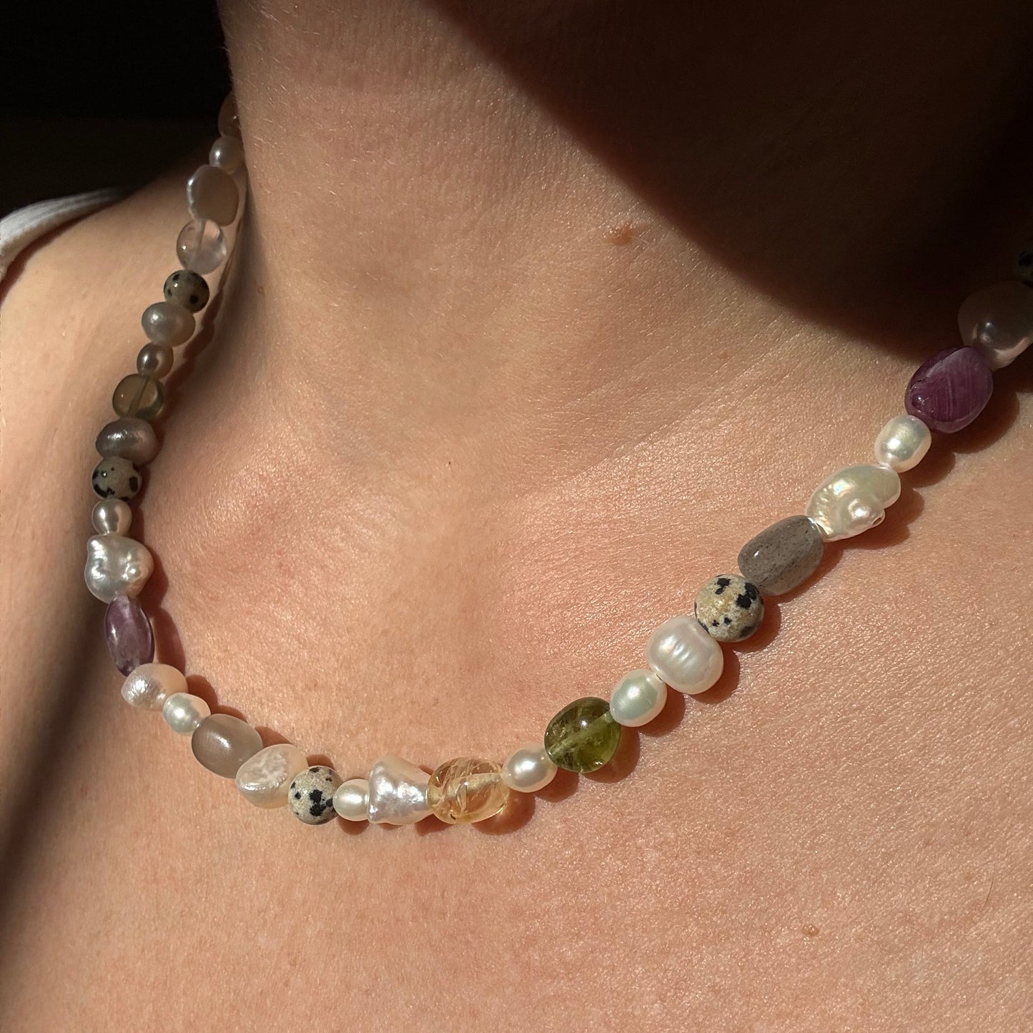 Multicolored beaded bracelet on a wrist with a neutral background