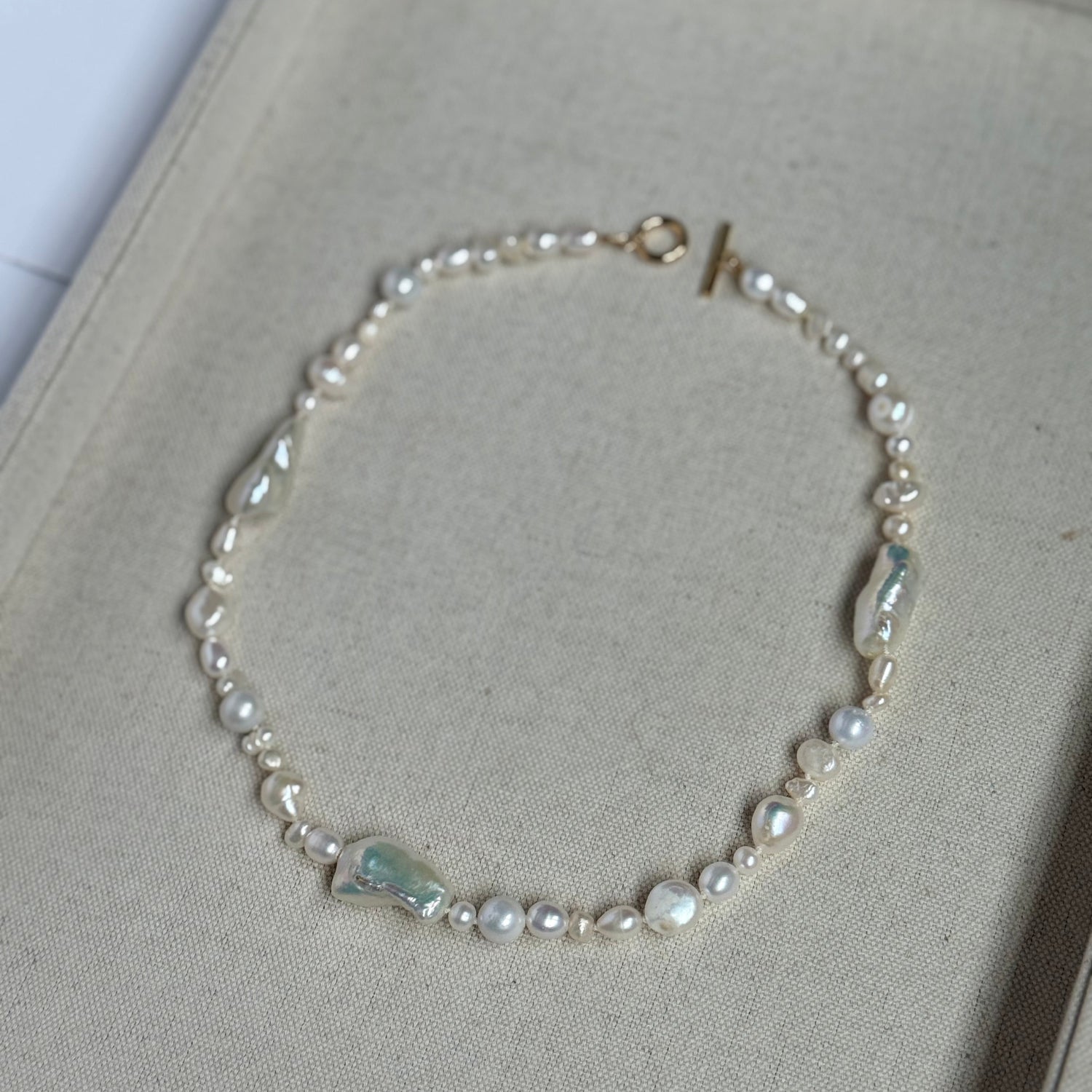 Pearl necklace on a light gray surface