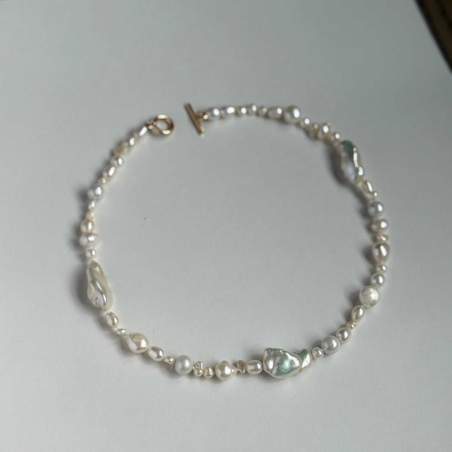 Pearl bracelet on a white surface