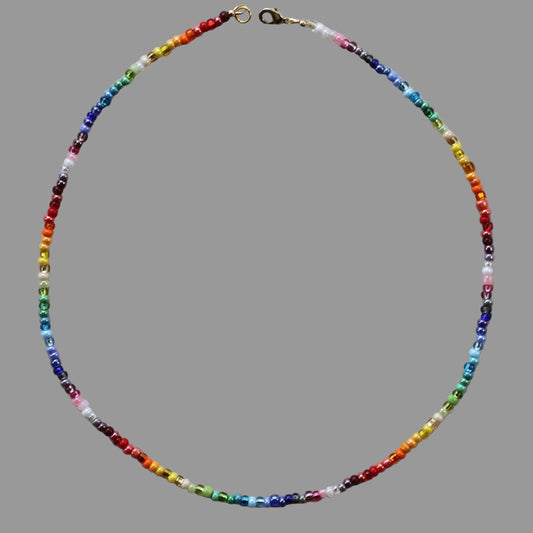 A beaded necklace with multicolored glass beads and a gold-filled lobster clasp.